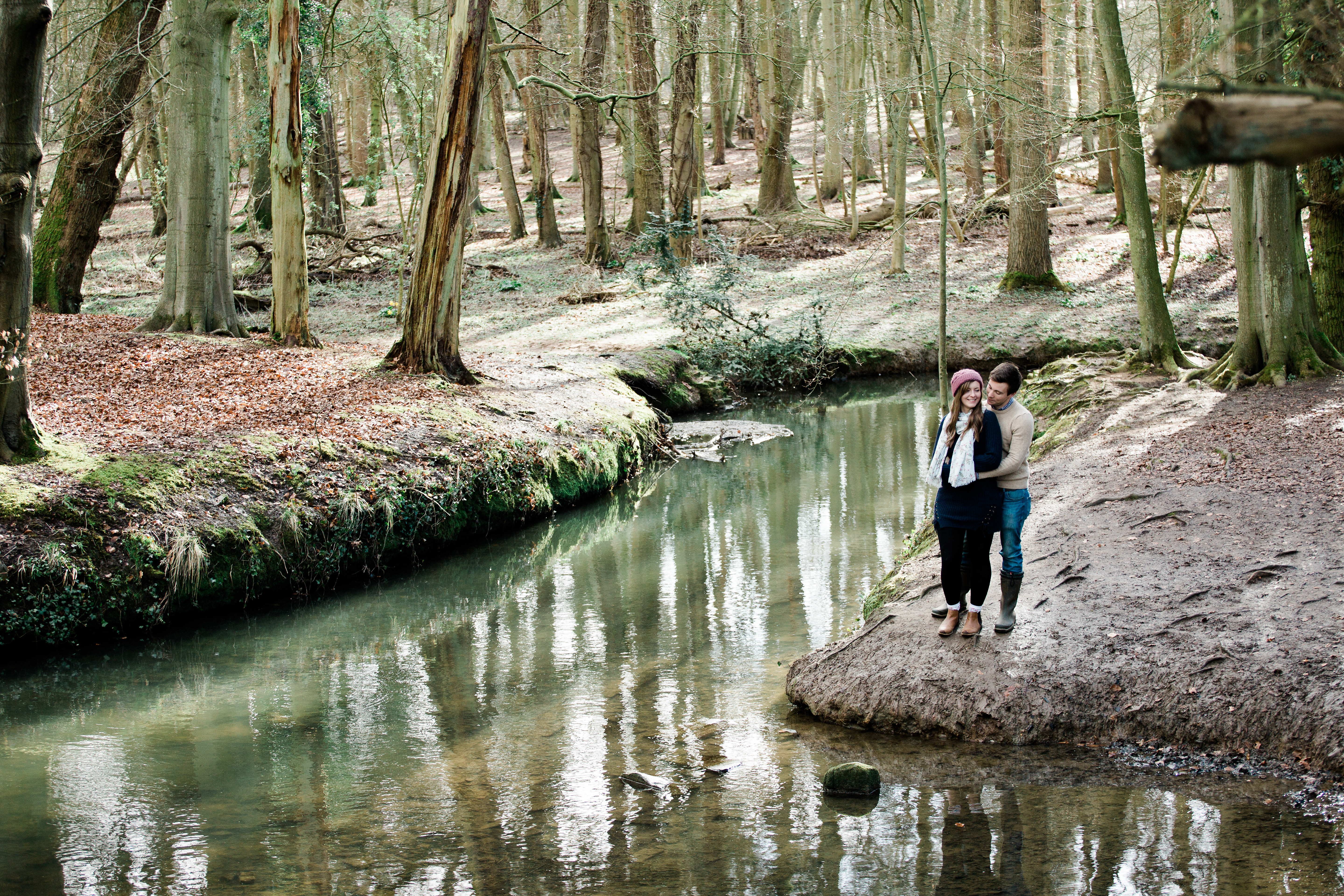 couple kiss next to river at Pre Wedding Shoot Coombe Abbey