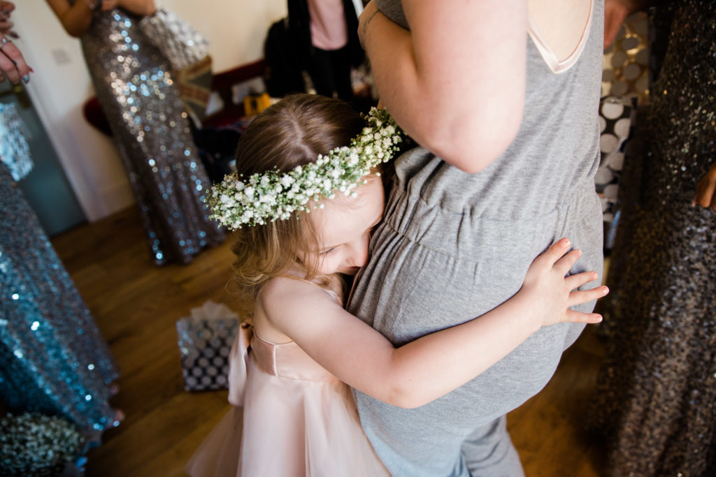 flower girl hugs mum when getting ready