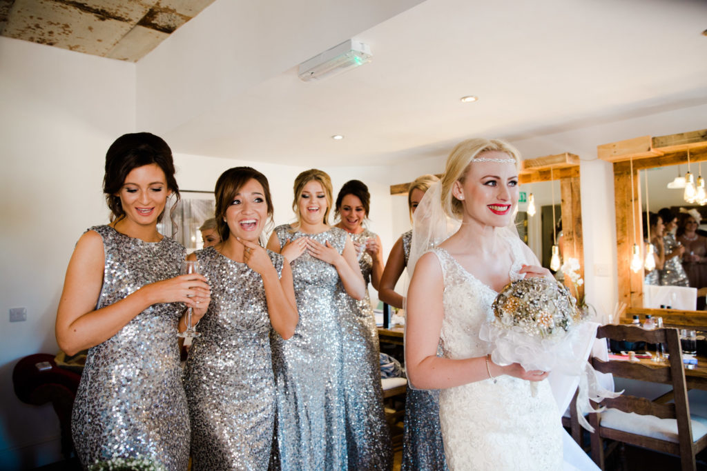 bride and bridesmaids laughing in dressing room west mill