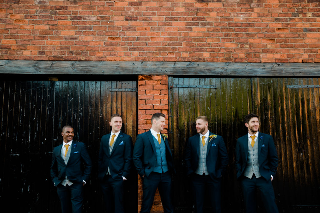 groom and groomsmen with blue and yellow colours