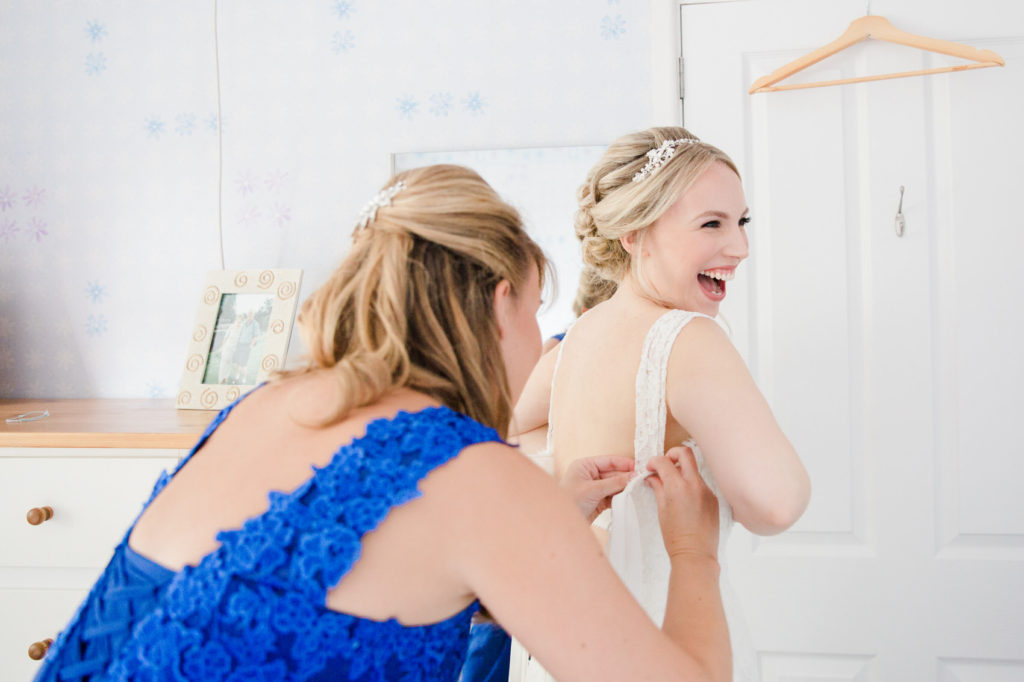 bride getting into dress
