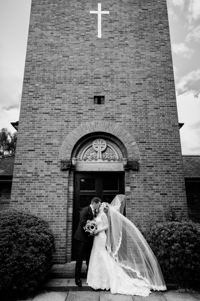 bride and groom kiss outside church sutton coldfeild