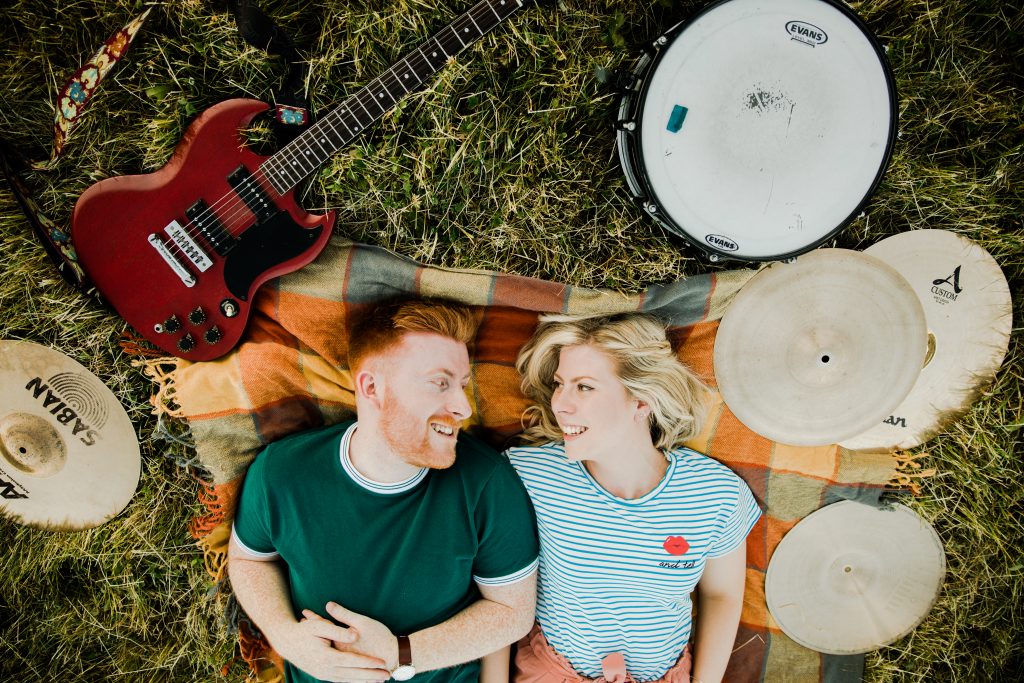 alternative music theme pre wedding shoot couple lay on ground surrounded by instruments